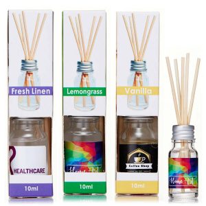 A set of three 10ml reed diffusers in various scents: Fresh Linen, Lemongrass, and Vanilla, in clear bottles with wooden reeds.