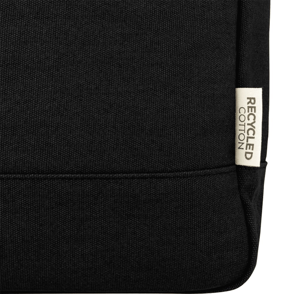 A black canvas backpack tote with a laptop compartment and sturdy handles, featuring a logo on the front.
