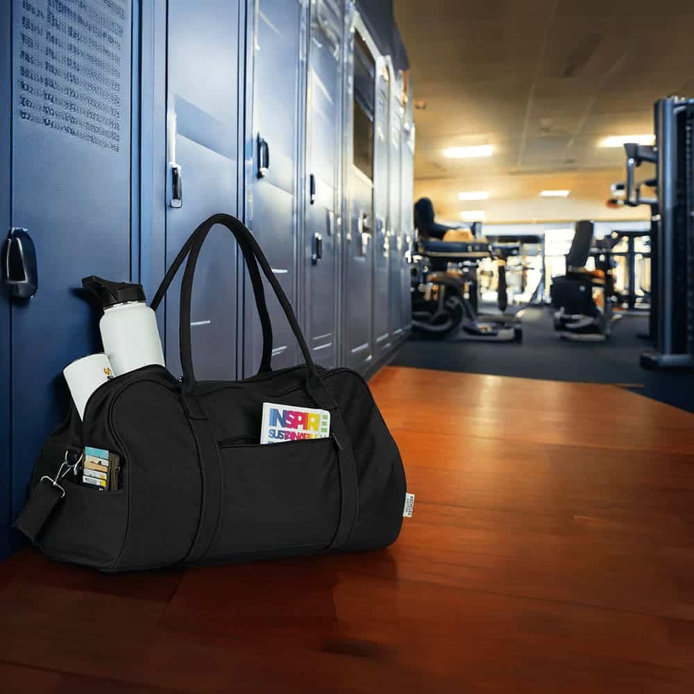 A black duffel bag with a zippered pocket, sturdy handles, and a logo. Ideal for travel or gym use.