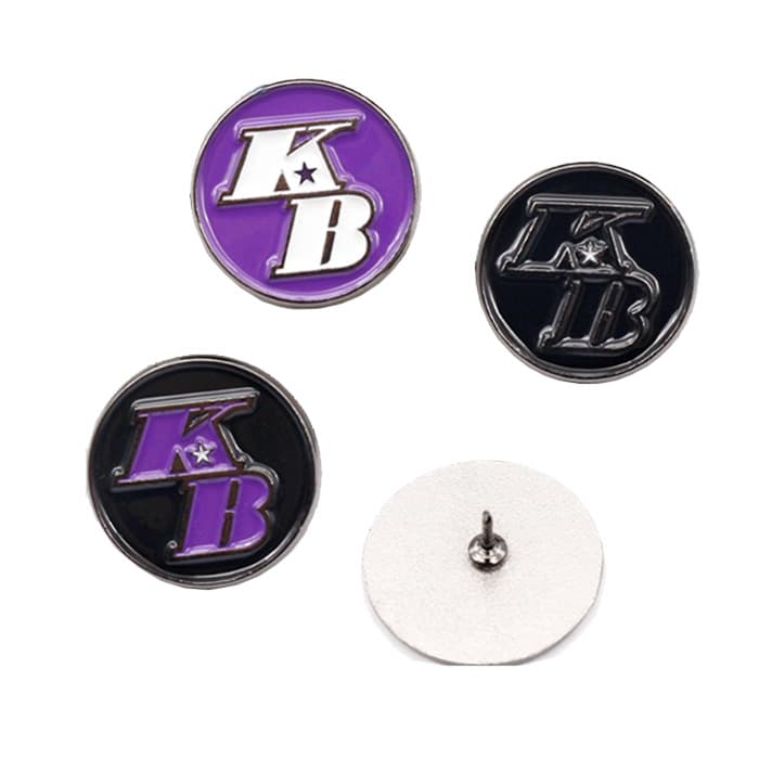 A set of Zinc Alloy Die Cast Lapel Pins in purple and black, featuring a logo and a backing post.