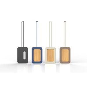A set of four luggage tags in black, navy, cream, and brown with a wooden panel and built-in loops. Each tag has a logo.