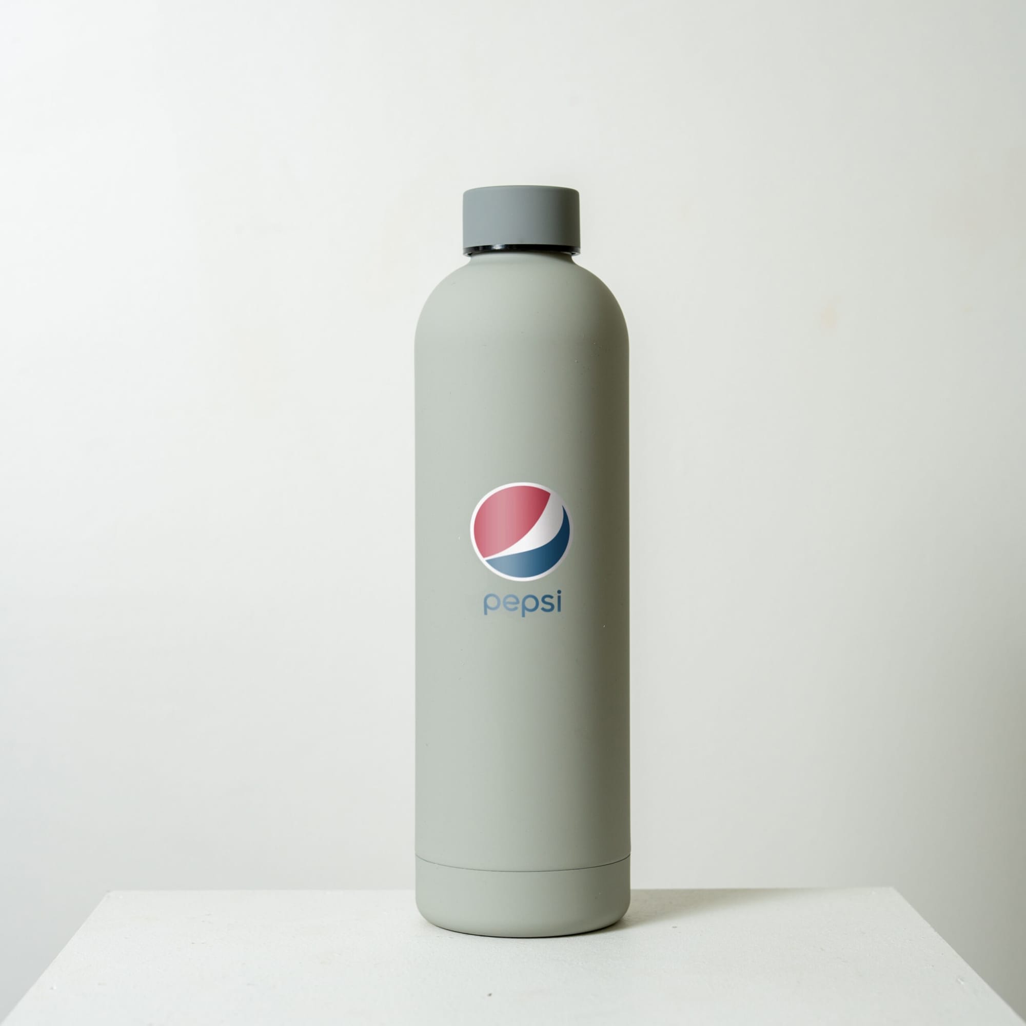 A drink bottle in grey, featuring a logo. The bottle has a sleek design with a wide mouth.