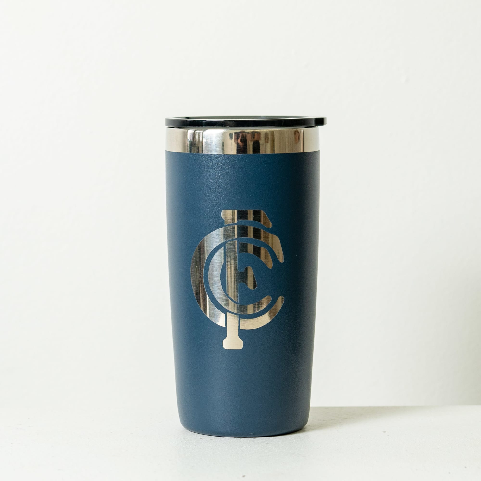 A drink bottle featuring a navy blue exterior with a metallic silver logo, topped with a black lid.