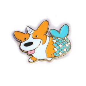 A playful enamel lapel pin featuring an orange and white corgi with a mermaid tail, accented with teal and pink details.