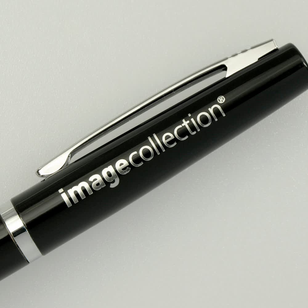 A black pen with a chrome clip and branding on the barrel.