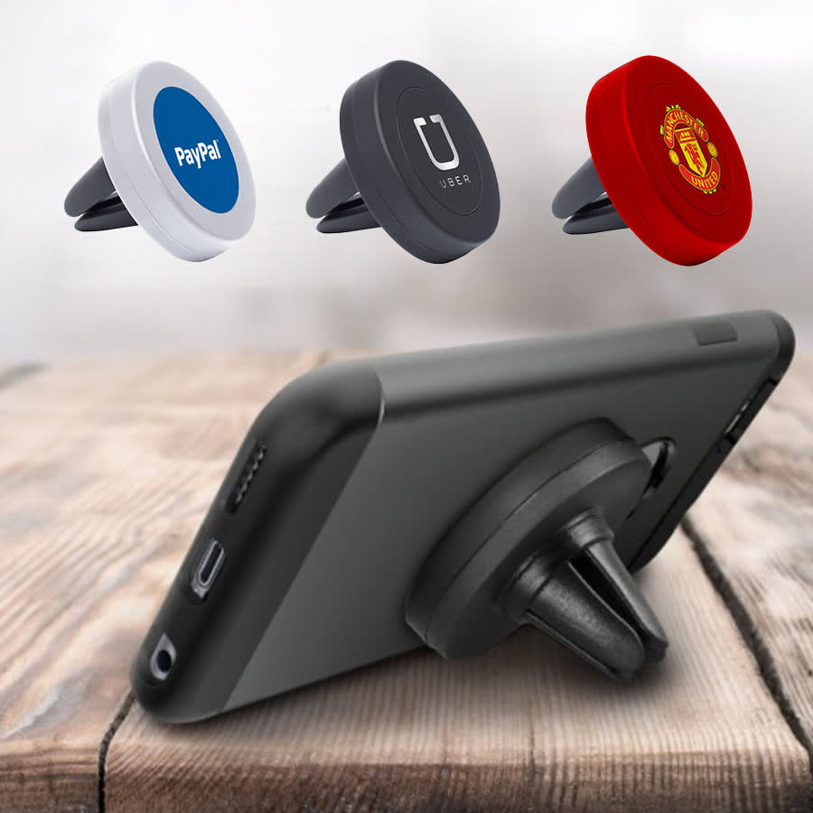 A phone holder with three varying coloured magnetic mounts: white, black, and red, displayed on a wooden surface.