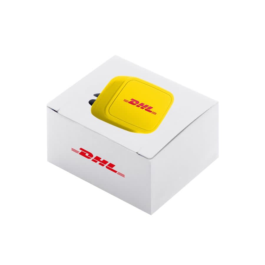 A yellow car phone mount is packaged in a white box featuring a logo. The mount is compact and square-shaped.