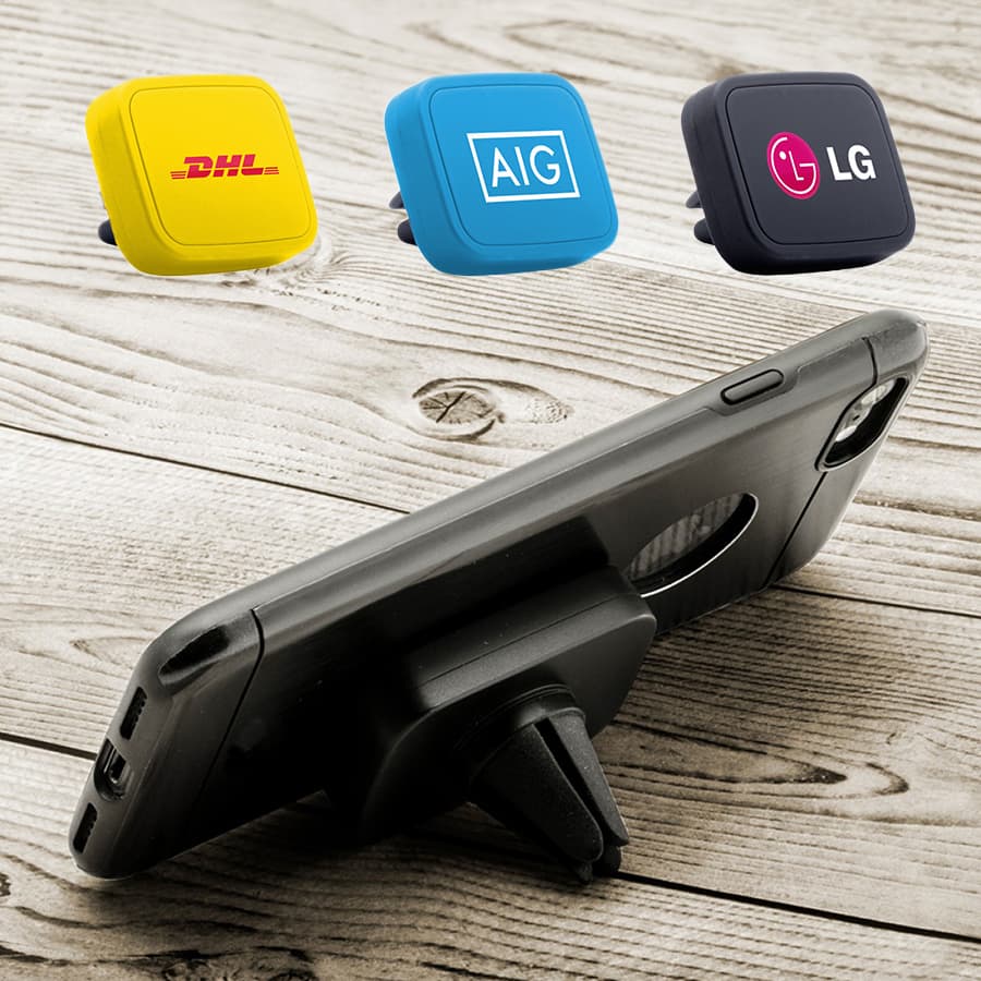 A universal magnetic car mount with three coloured magnets in yellow, blue, and black, displayed with a smartphone on a wooden surface.