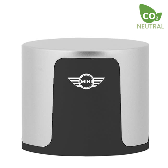 A cylindrical wireless speaker in silver and black, featuring a logo on the front.