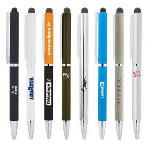 A collection of eight metal ballpoint pens in various colours with stylus tips, featuring different logos on each.