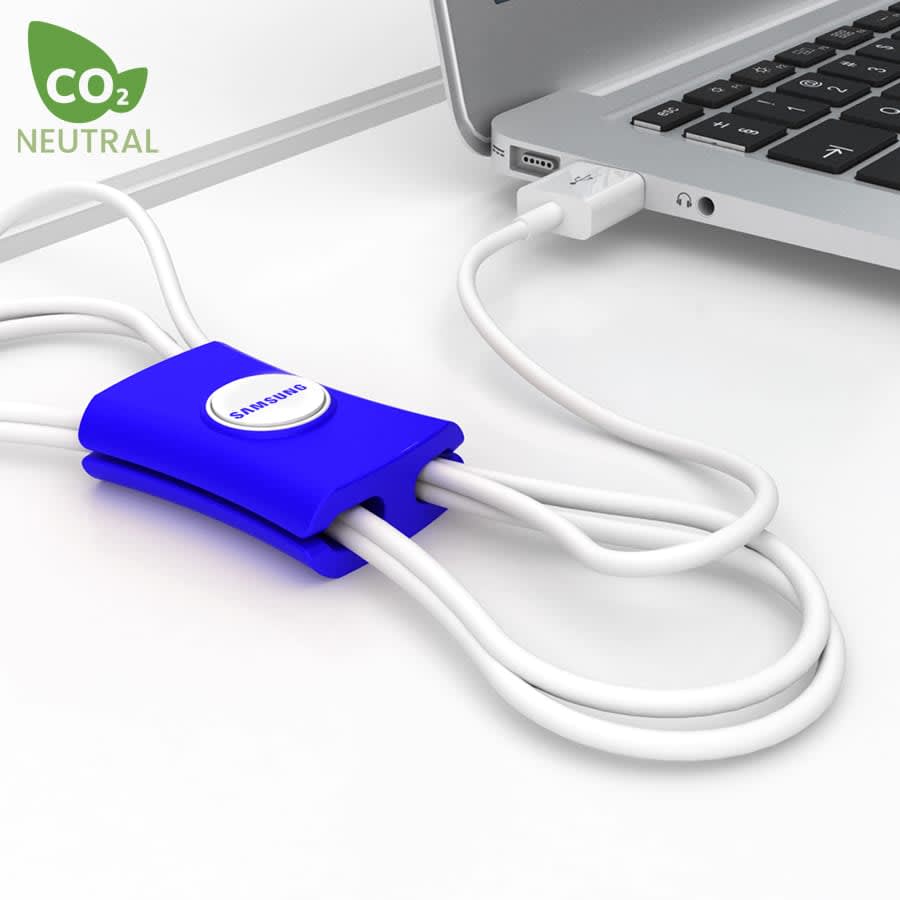 A blue cable manager designed to organise cables, placed next to a laptop and connected to a USB port.