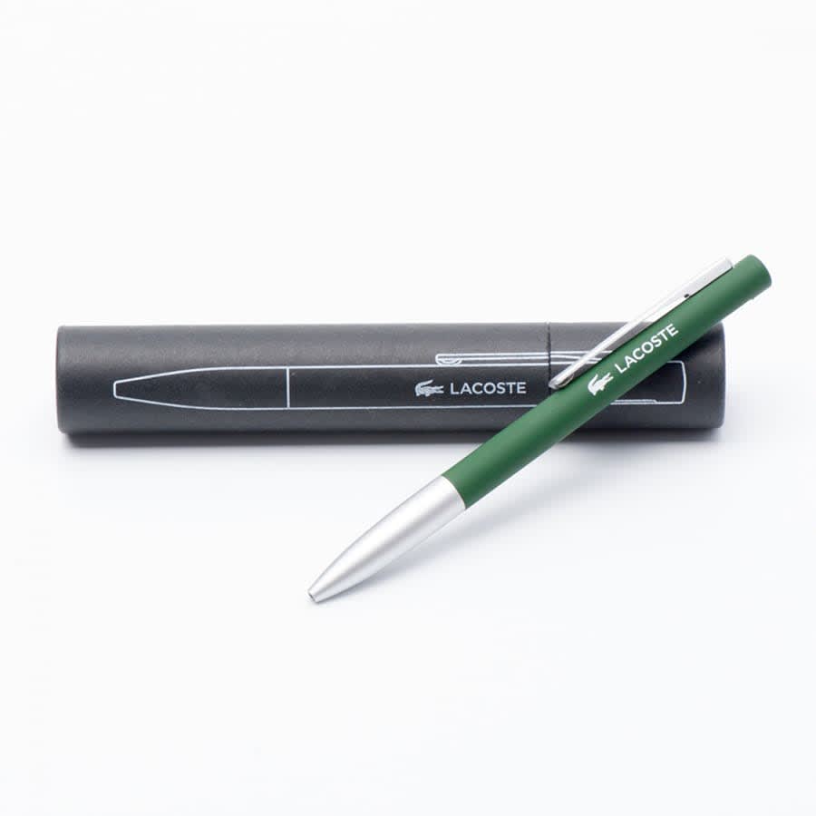A green metal ballpoint pen with a silver tip, resting on a black pen case featuring a logo.