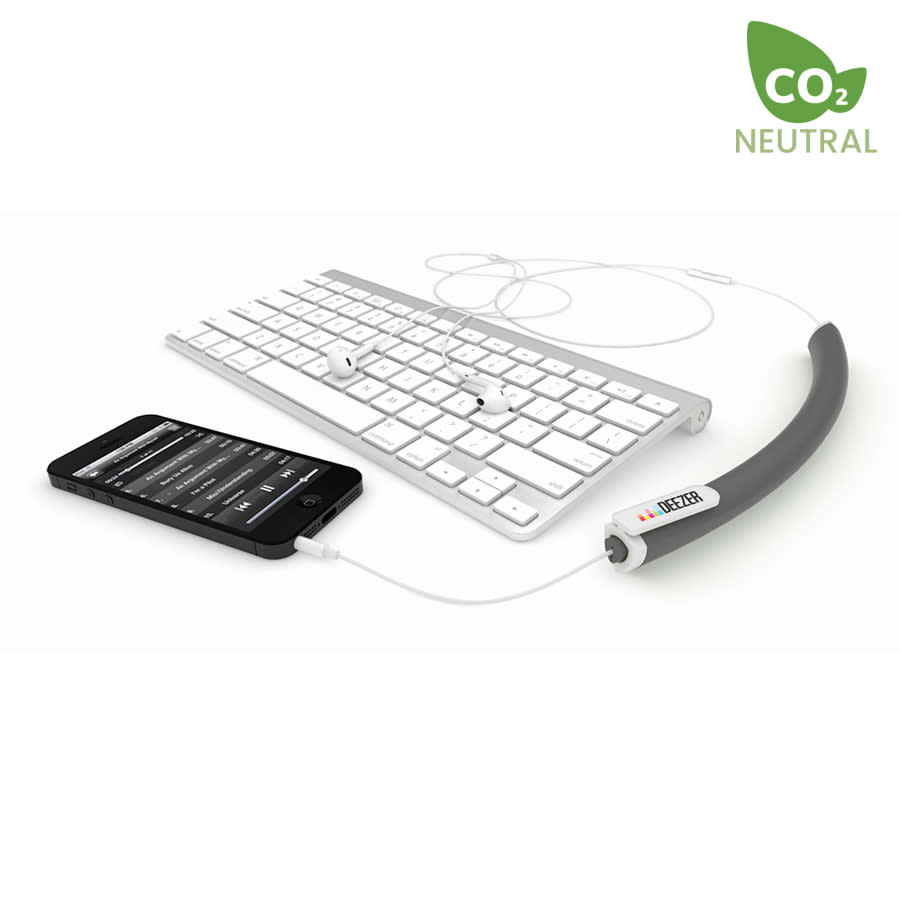 A black earbud organiser lays next to a smartphone and a keyboard, with earbuds neatly arranged alongside it.