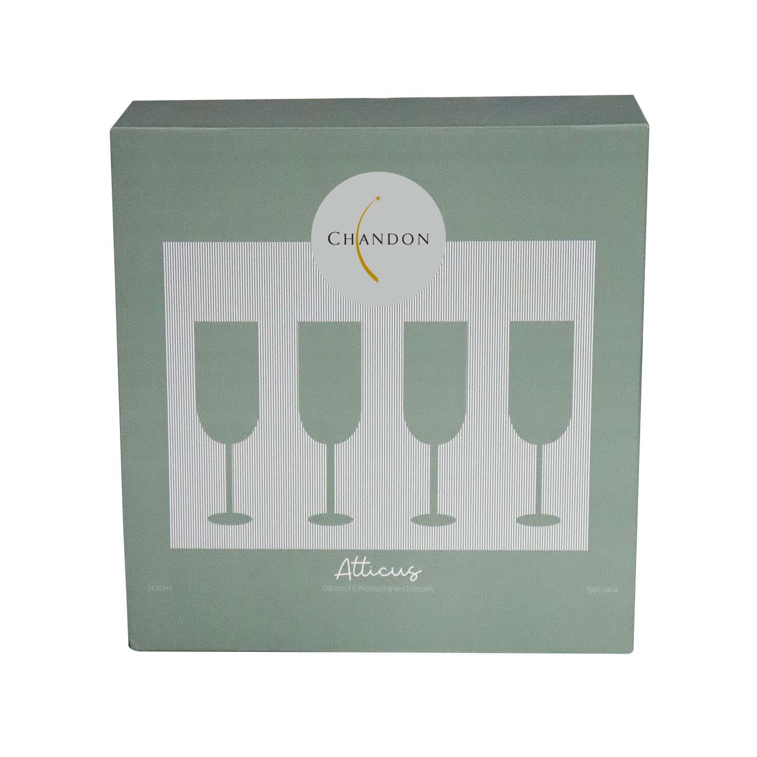 A green box containing four ribbed champagne glasses, featuring a circular logo on the front.