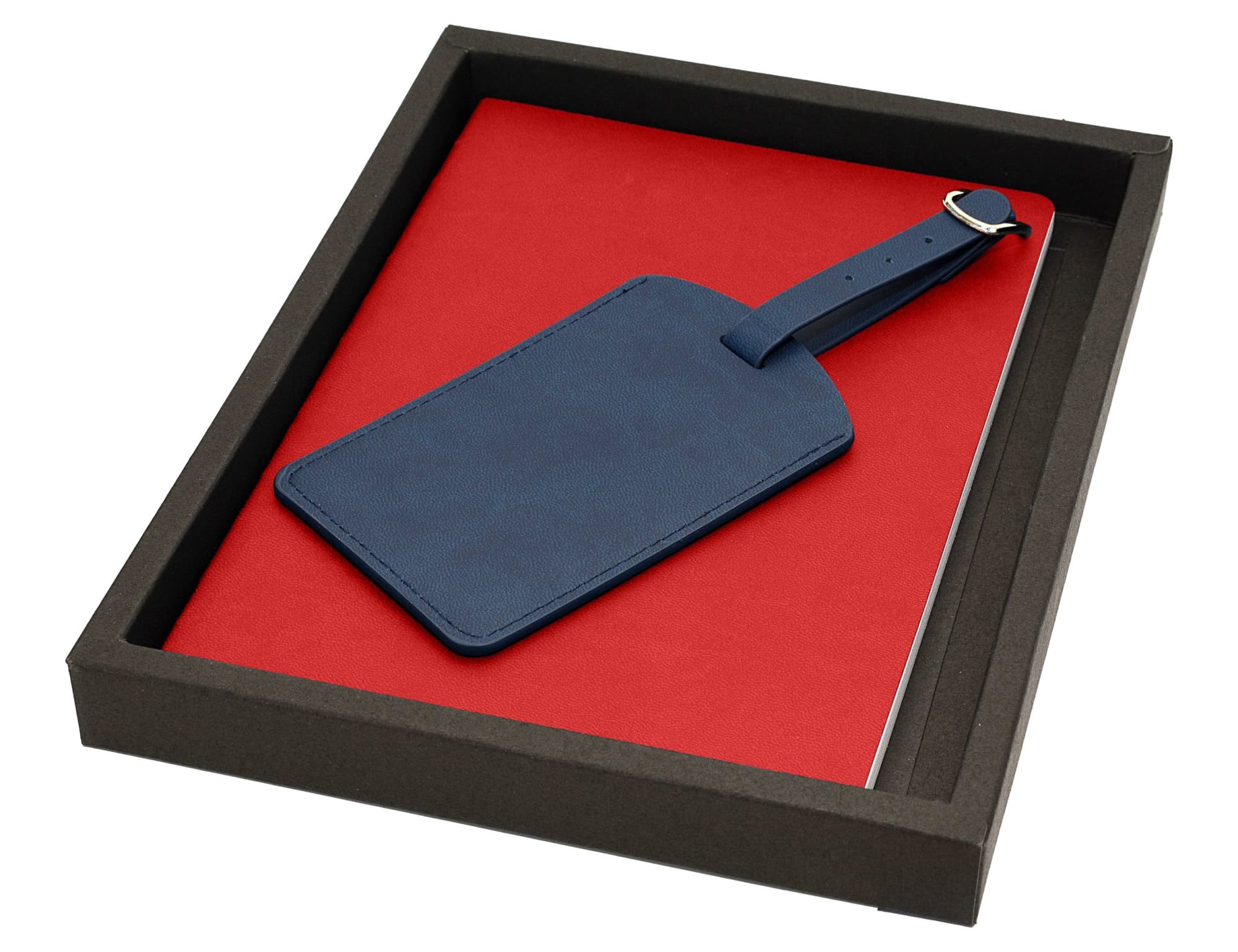 A red notebook and a navy blue luggage tag presented in a black gift box.