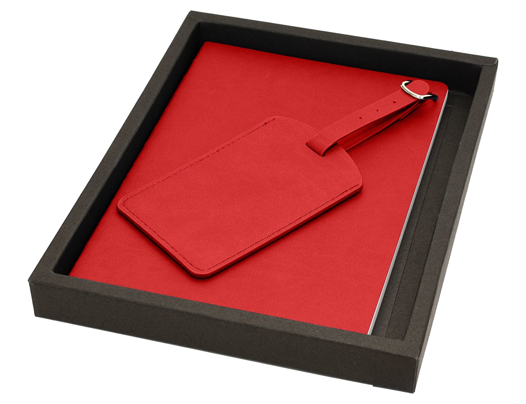 A red travel journal accompanied by a matching luggage tag, presented in a black box.