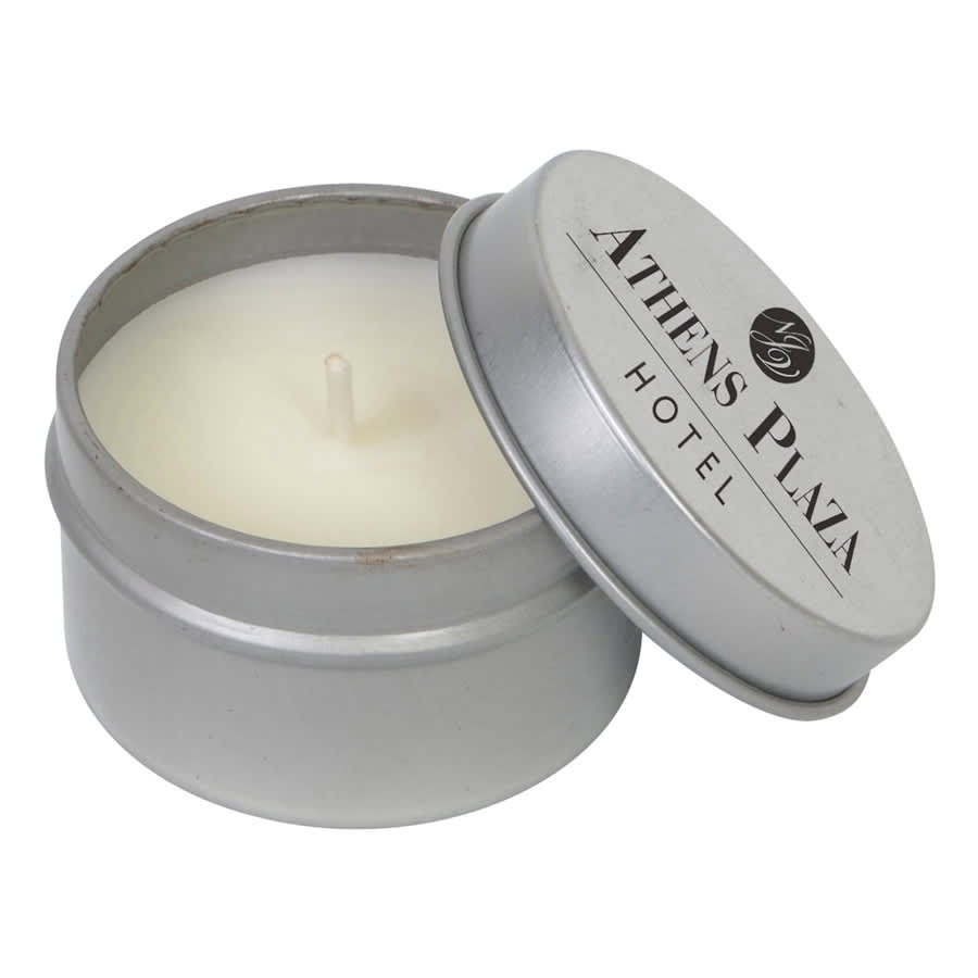 A silver tin containing a vanilla scented candle, partially open, with a white wax interior and a visible wick.