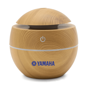 A wooden-style diffuser in a rounded design, featuring a logo and a power button on top.