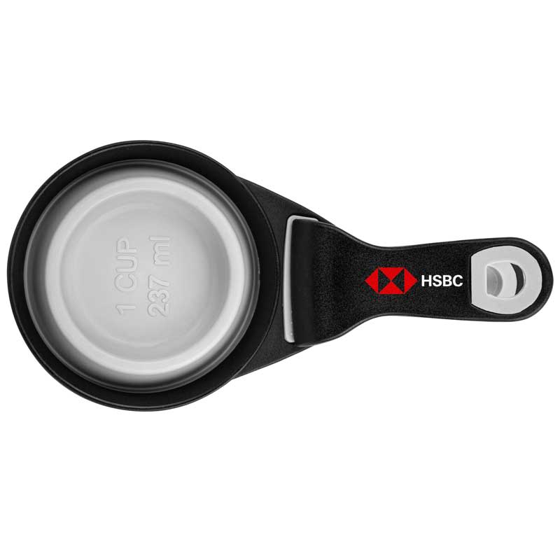 A black collapsible silicone pet food scoop with a silver interior, featuring a logo.