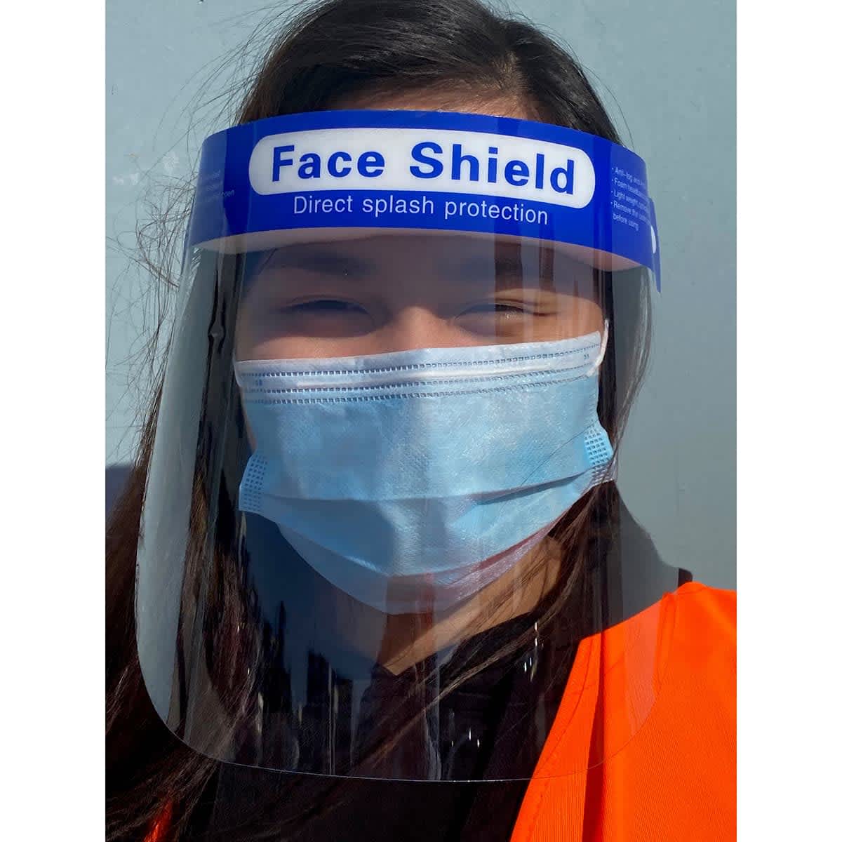 A full-length face shield with a blue top and transparent visor, worn by a person in a face mask and orange vest.