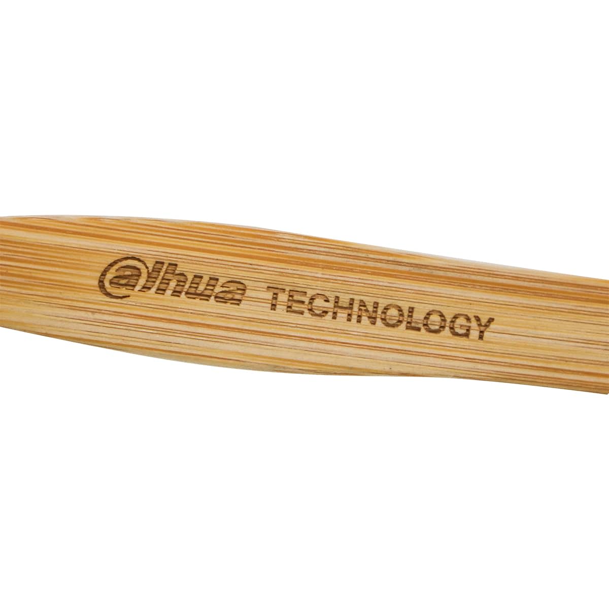 A bamboo toothbrush with a wooden handle and a logo engraved on the side.