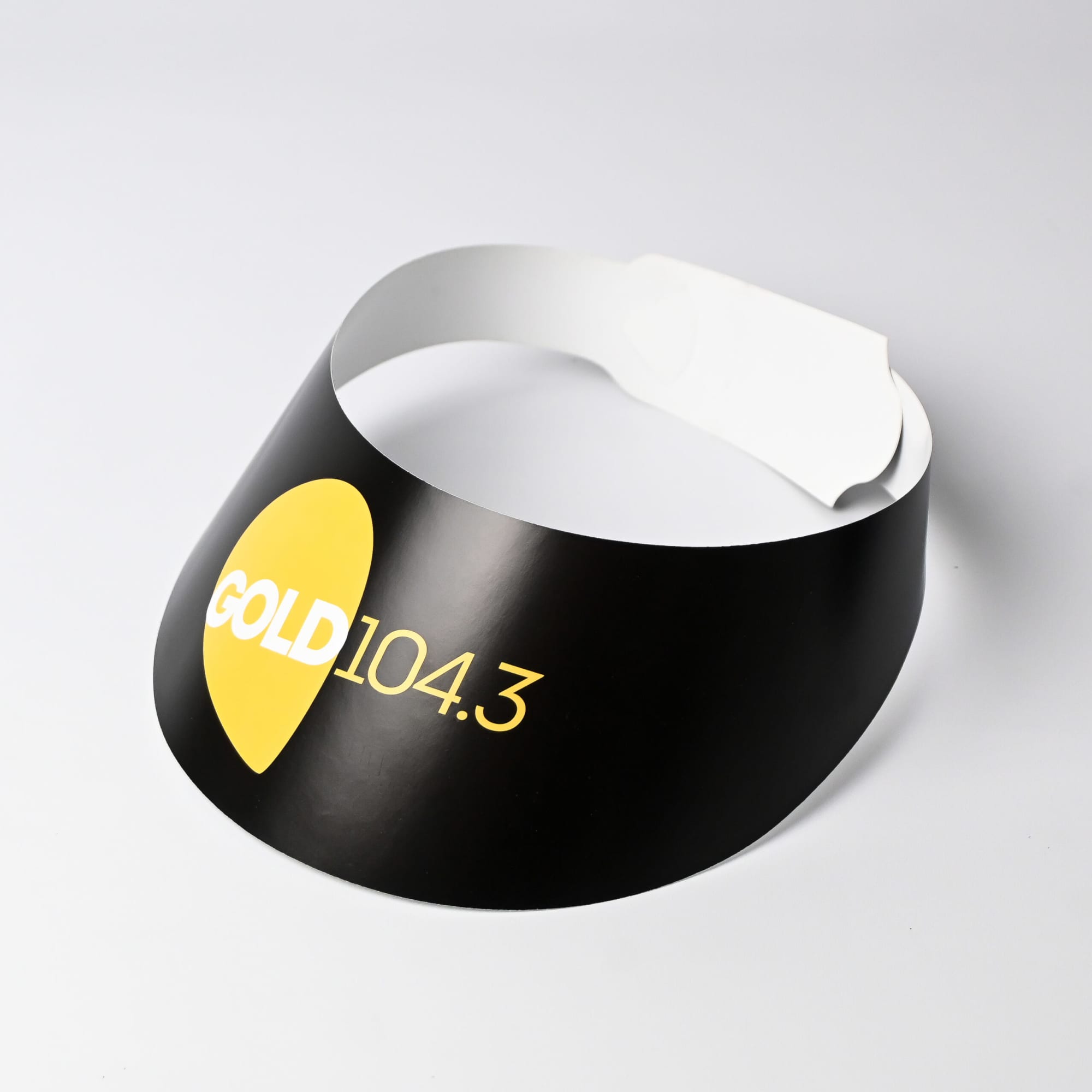 A black sun visor featuring a yellow logo, with a white adjustable strap and an Australian Made label.
