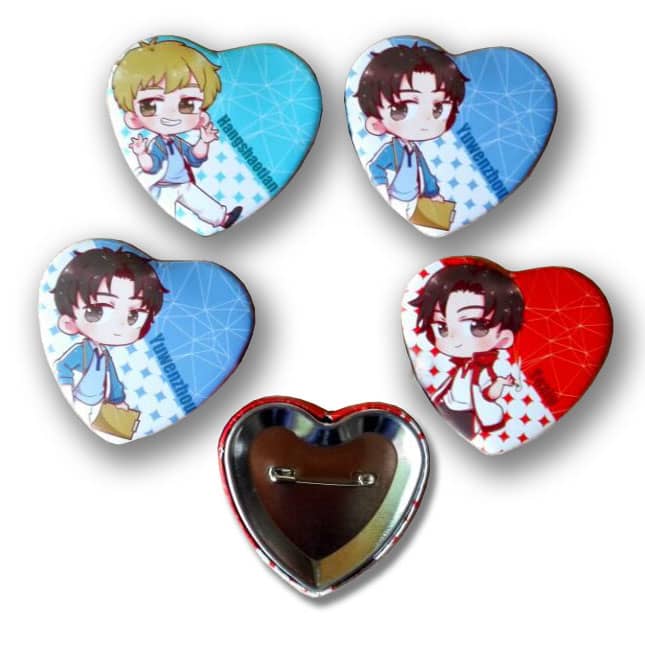 Four heart-shaped button badges featuring colourful characters, with a silver backing and a pin attachment.