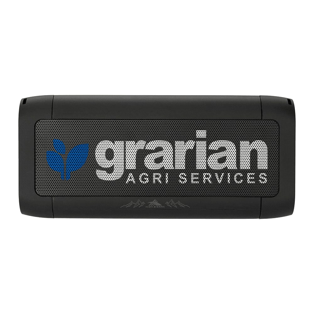 A black power bank with wireless charging feature, paired with a smartphone displaying a charging indicator.