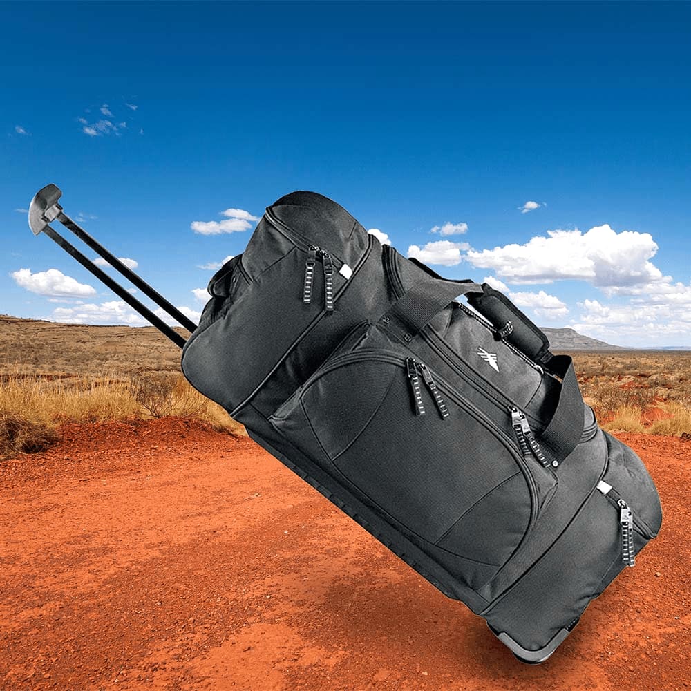 A black wheeled duffel bag with multiple compartments and a logo on the front.