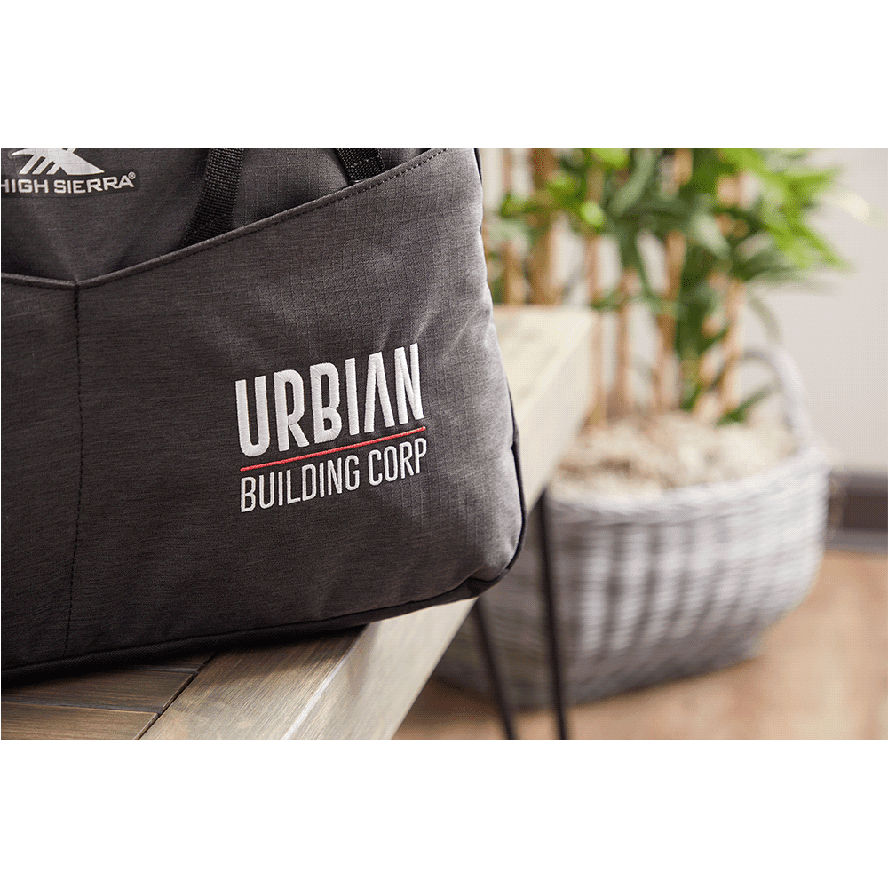A large, grey duffel bag with multiple compartments and a shoulder strap, featuring a logo on the front.