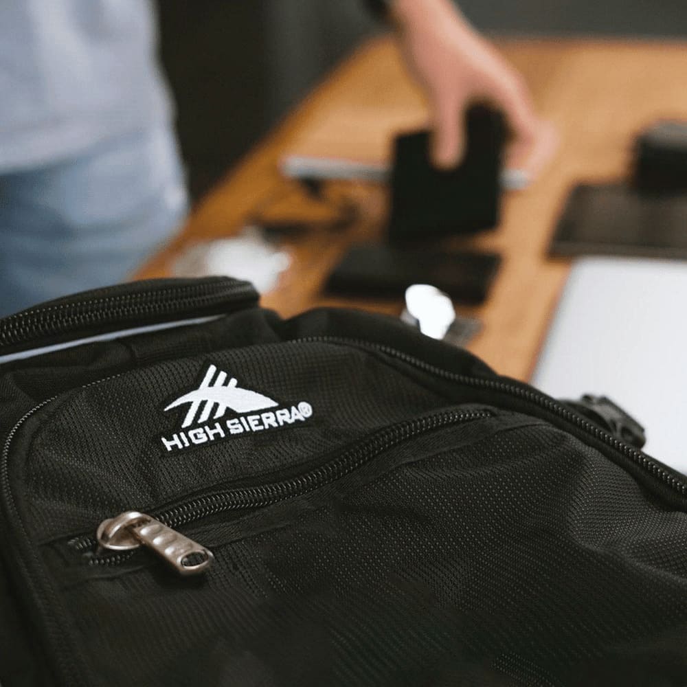 A black High Sierra Access 3.0 Backpack with a textured finish and an exterior mesh pocket.