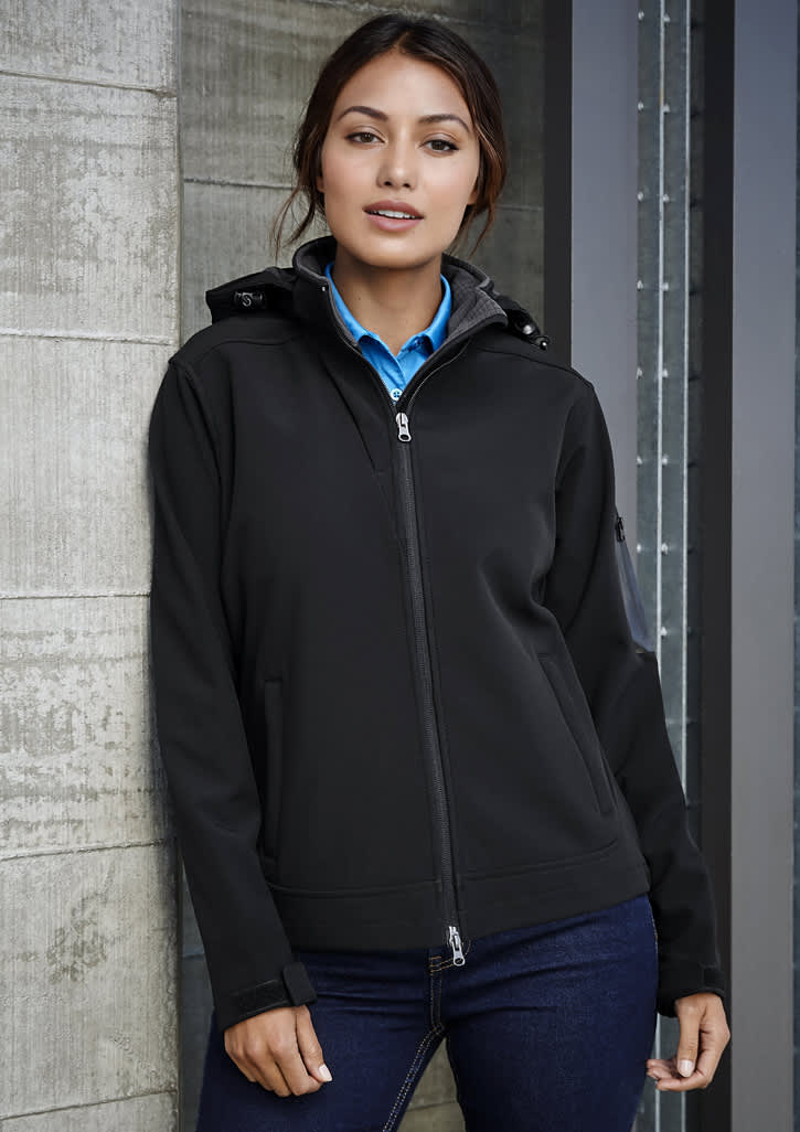 A black women's soft shell jacket with a hood, featuring a zip front and a branded logo.