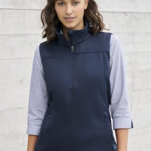 A women's softshell vest in navy blue, featuring a zip front and a high collar, with a fitted design.