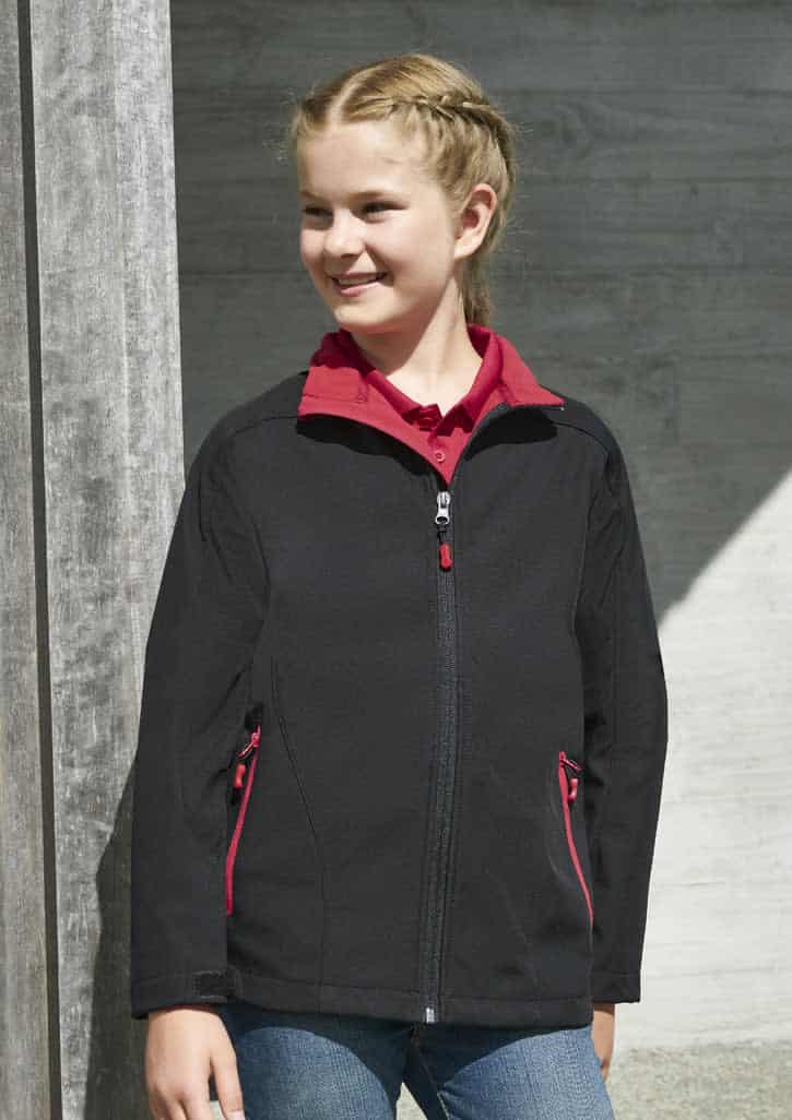 A black kids' jacket featuring red zip accents and side pockets, worn by a smiling child.