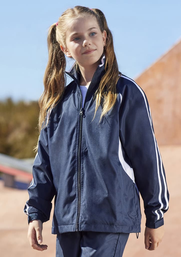 A girl in a navy track jacket with white stripes, featuring a high collar and zip closure.
