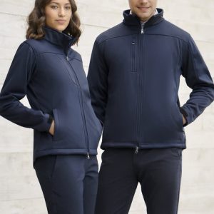 A navy softshell jacket featuring zip pockets and a high collar, worn by a man and a woman. The image has a subtle background.