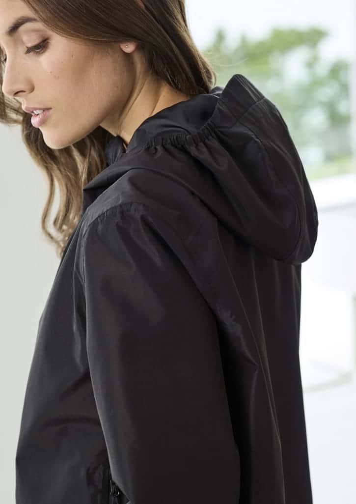 A black women's rain jacket with a hood, featuring a fitted design and lightweight fabric. It has branding visible.