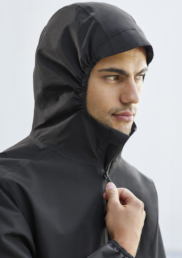 A man wears a black rain jacket with a hood, featuring a fitted design and a zippered front.
