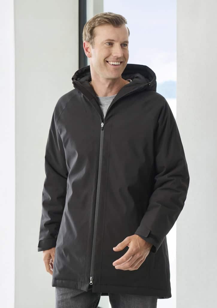 A man is wearing a black unisex rain jacket with a hood, featuring a zip and a sleek design.