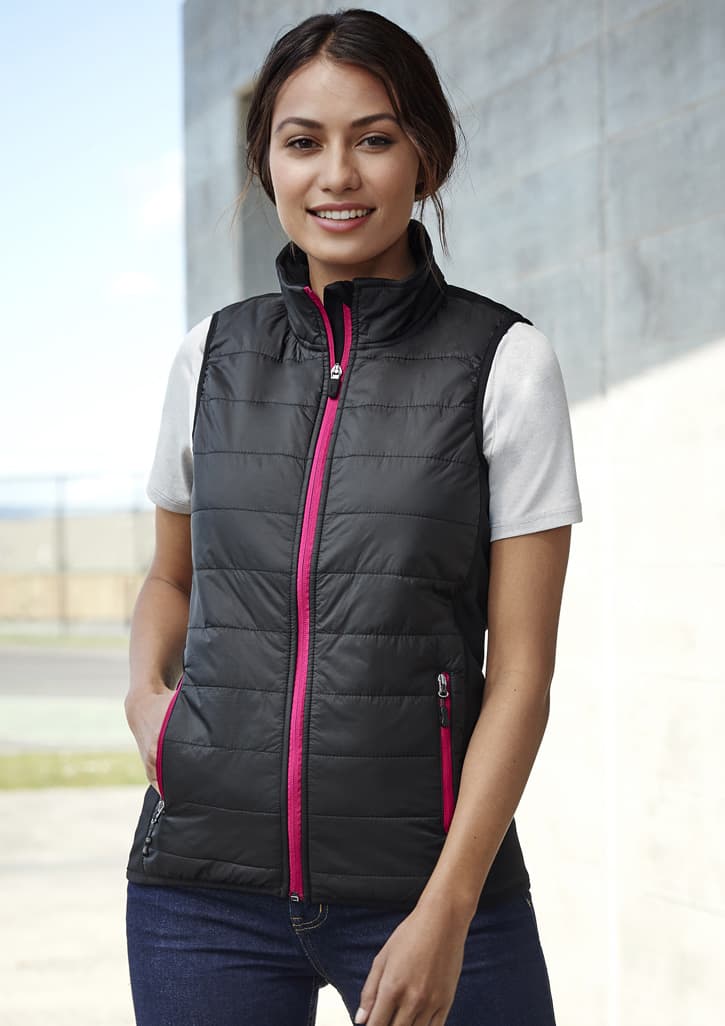 A black women's vest with pink zippers and pockets, featuring a quilted design and a high collar.