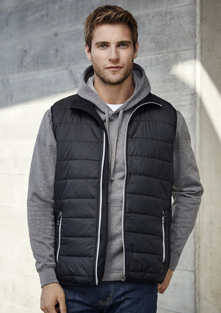 A black men's vest with a quilted design, featuring a zipper and a hood worn over a grey hoodie.