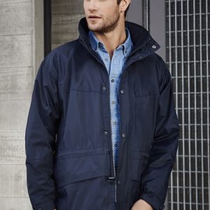 A navy unisex Trekka jacket is worn by a man, featuring a zip and snap closures, with a branded logo.