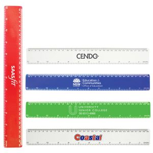 A set of plastic rulers in red, blue, green, and clear, featuring various branding and measurement markings.