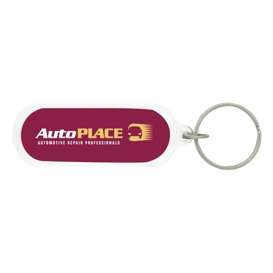 An oval acrylic keychain with a transparent body and a metal ring.