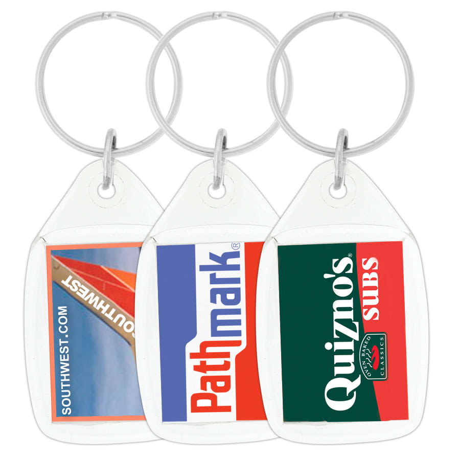 A hand holds a clear tear drop acrylic keychain featuring the Australian flag. The keychain has a silver ring and a logo.