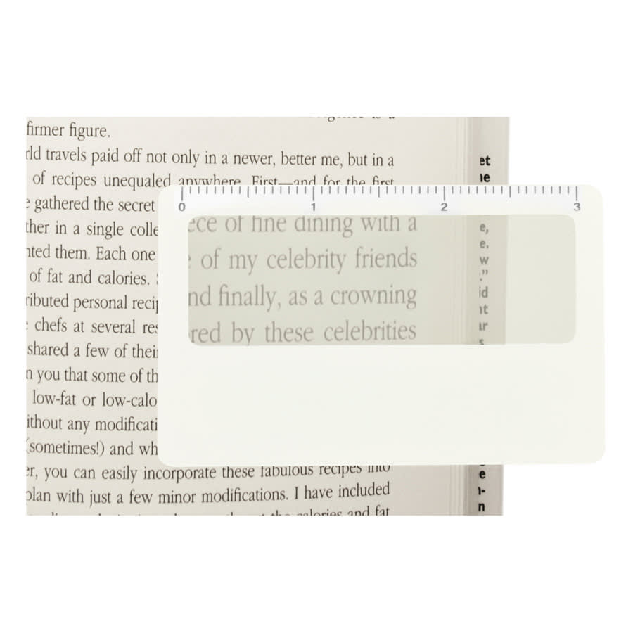 A pocket ruler magnifier with a transparent sleeve, measuring up to 15 cm, against a page of text.
