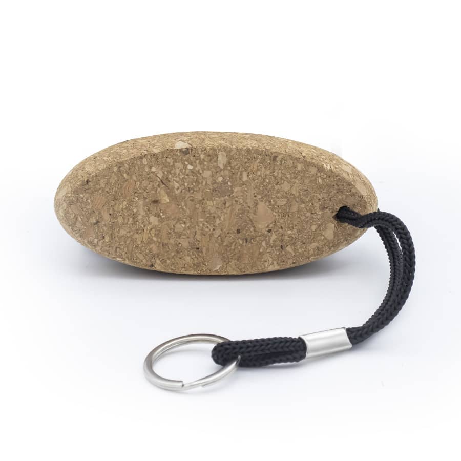A cork keychain with an oval shape and a black strap for attaching. It features a metal keyring.
