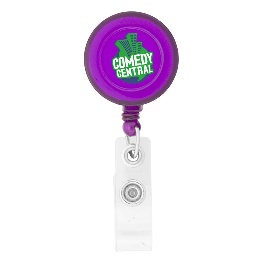 A round badge holder in purple with a clear clip, featuring a logo on the front.