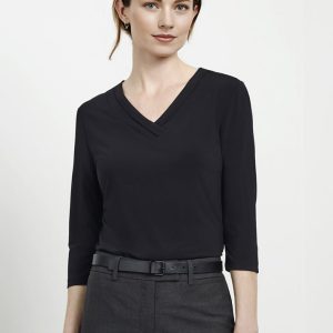 A black 3/4 sleeve top with a V-neck design, worn by a model with a sleek hairstyle and grey trousers.
