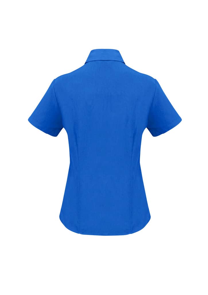 A blue short sleeve button-up shirt with a collar and a logo on the back.